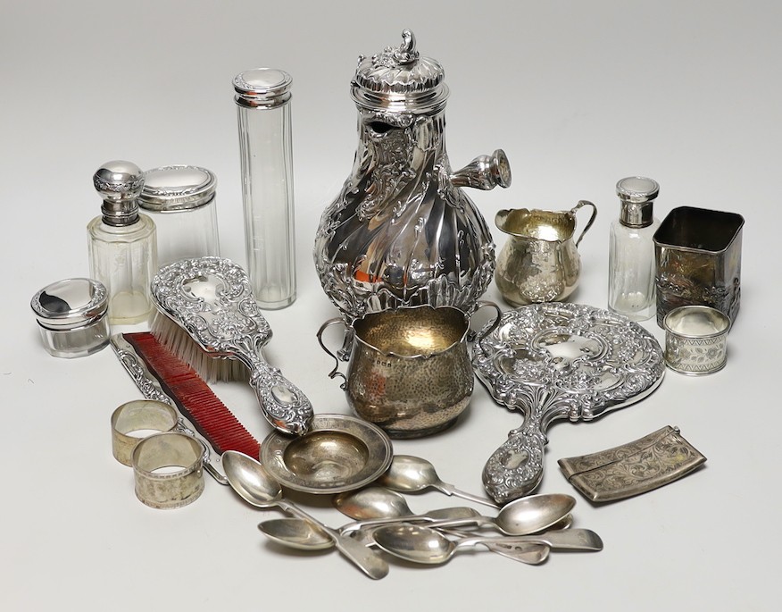 A late 19th/early 20th century French white metal coffee or chocolate pot (lacking handle), gross 21.5oz, a silver cream jug and sugar bowl, five French white metal mounted toilet jars, three silver napkin rings, a silve